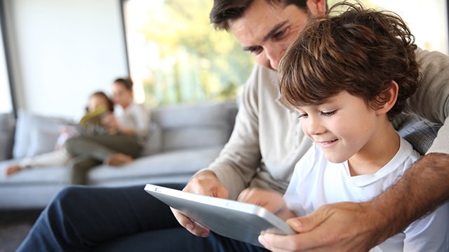 Father and son looking at a tablet