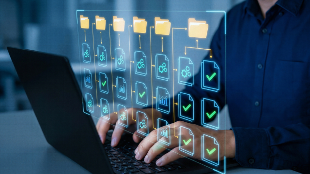 Person typing on computers with folder structure overlayed on image
