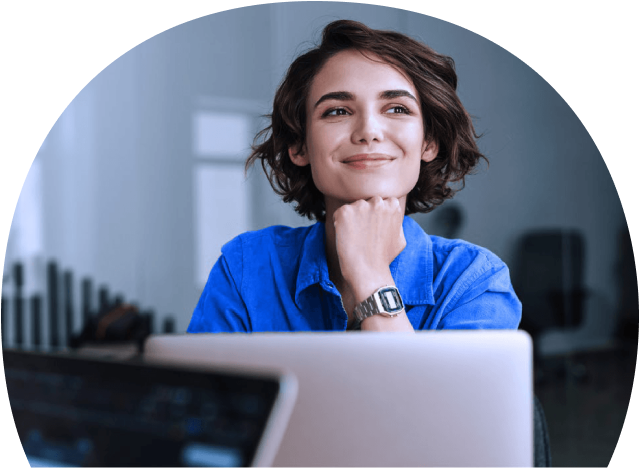 Person smiling in front of computer