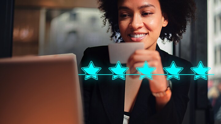 Woman browsing on her laptop sees five star rating