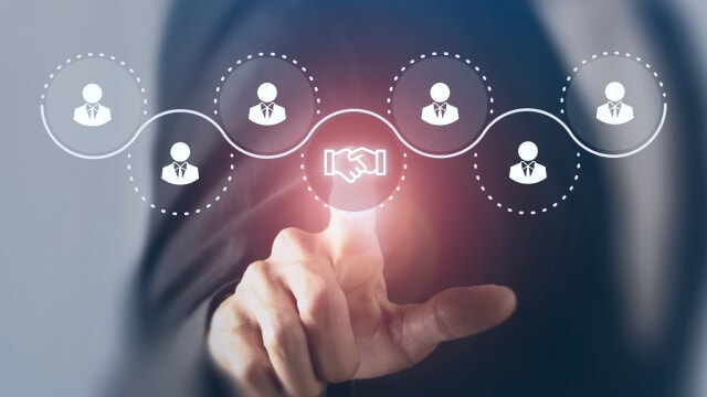 Hand touching a handshake icon connected to a network of people icons