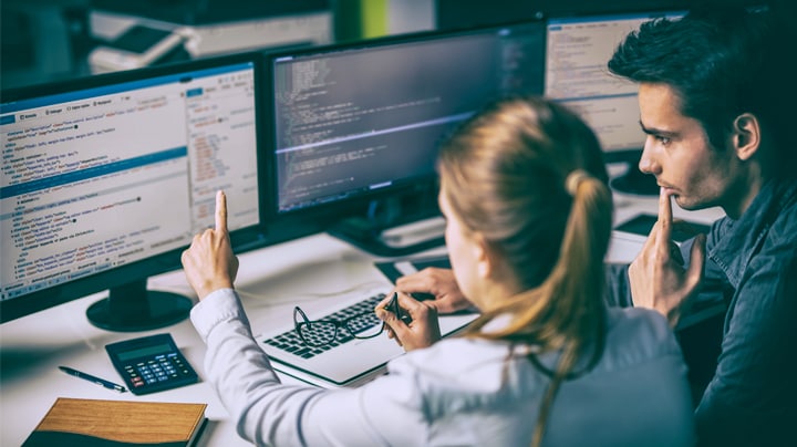 colleagues reviewing information on screens