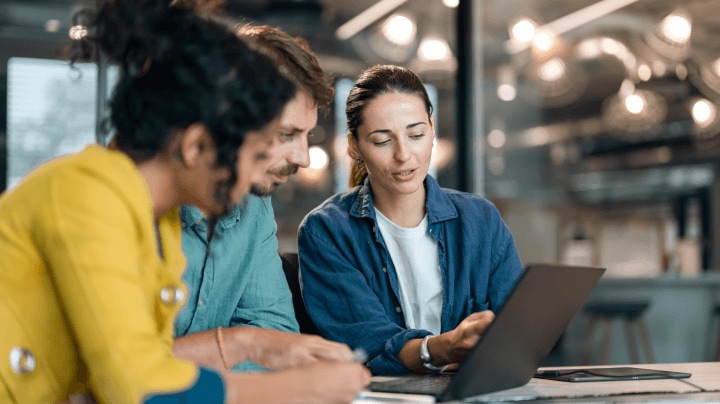 co-workers looking at a laptop
