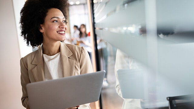 Person on a laptop smiling.