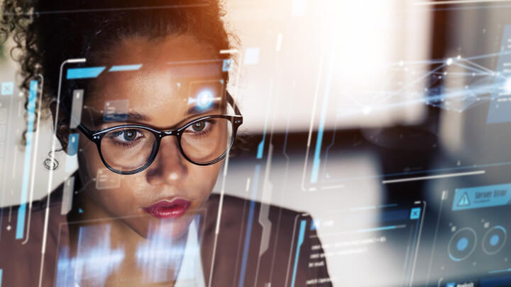 A person looking at a computer monitor 